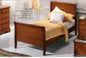 Single sleigh bed, inlaid on walnut. Dimensions: cm 94x219x100x72.